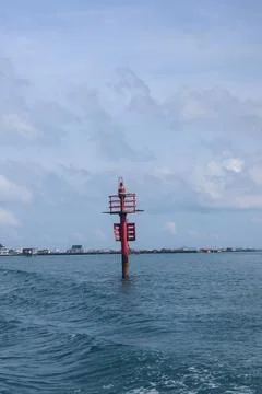 Red Navigation Beacon in the Middle of the Sea Fotos Stock