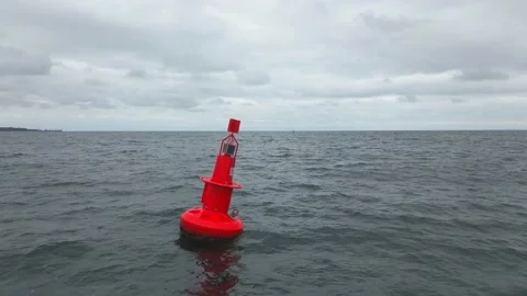 Red Navigational buoy in sea with clouds slow motion Stock Footage 224710664