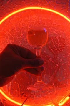 Red neon light illuminating the interior of a modern pub Stock Photos