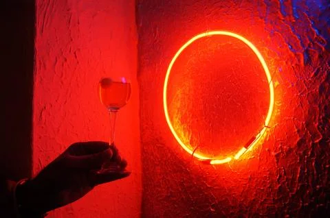 Red neon light illuminating the interior of a modern pub Stock Photos