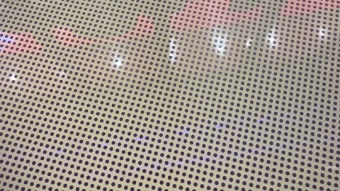 Red Neon Light Reflections on Black and White Polka Dot Surface Stock Footage 330520493