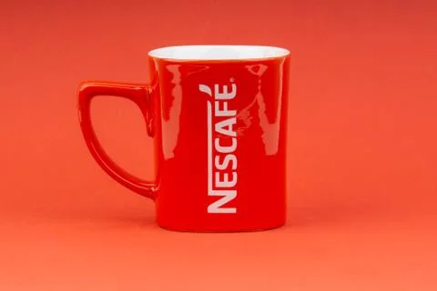 Red Nescafe mug isolate on red background Stock Photos