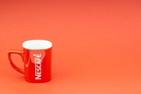 Red Nescafe mug isolate on red background Stock Photos