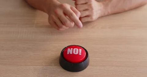 Red NO button on wooden desk with folded hands, symbol of refusal and stop Stock Footage 319101993