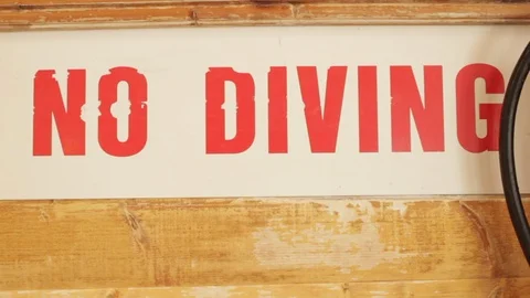 Red No Diving warning sign at the swimming pool Stock Footage 107626498