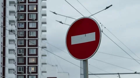 Red no entry traffic sign in front of a modern apartment high-rise, with Video stock 327730301