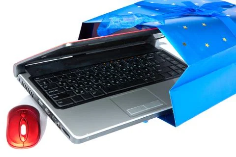 Red notebook and a computer mouse are packed into a gift packet by New year.. Stock Photos