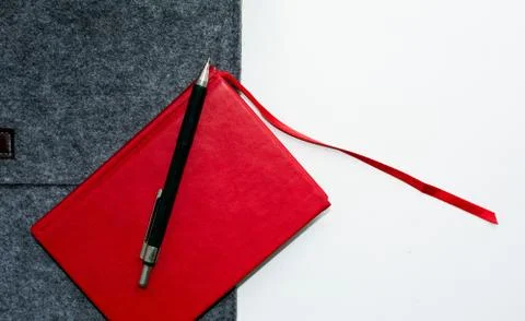 Red notebook gray folder and pen on white background Stock Photos