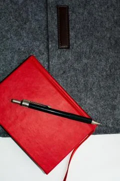 Red notebook gray folder and pen on white background Stock Photos