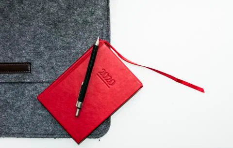 Red notebook gray folder and pen on white background Stock Photos