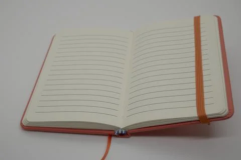 Red notebook with lines for text on a white background Stock Photos