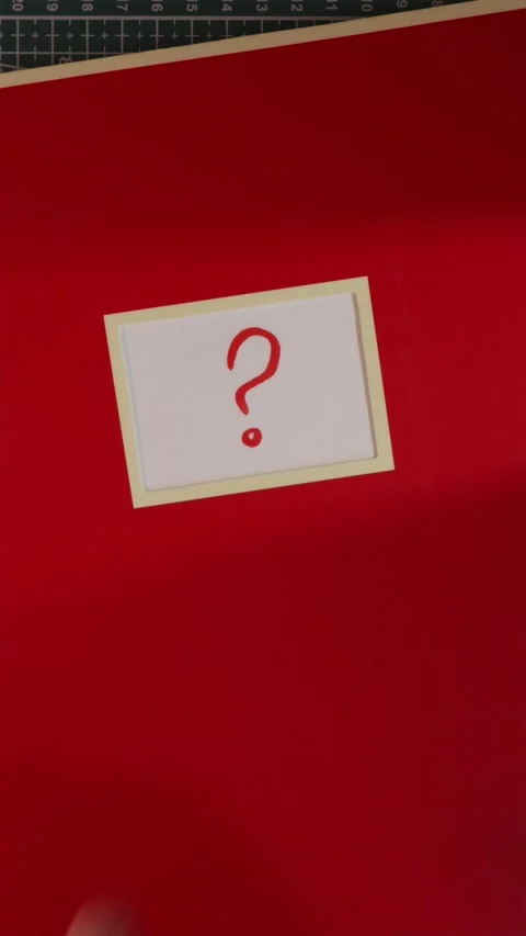 Red notebook with question mark label top down view Stock Footage 341246148