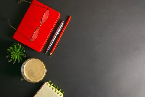 The red notebook stands on a black background, on the notebook there are glas Stock Photos