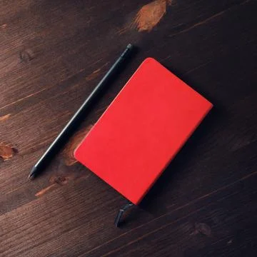 Red notepad, pencil Stock Photos