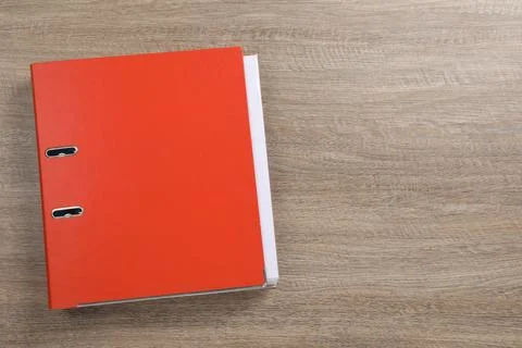Red office folder on wooden table, top view. Space for text Stock Photos
