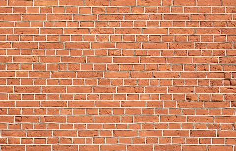 Red old brick wall with gray cement joints Stock Photos