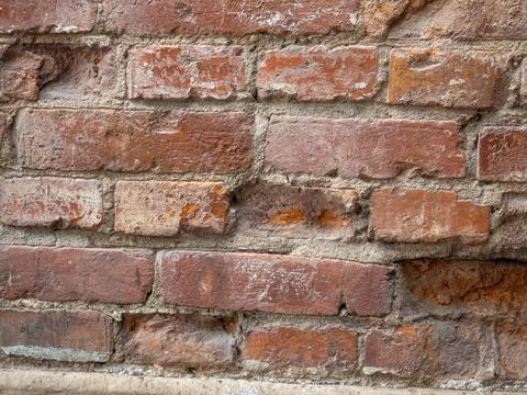 Red old brickwork. Chipped brick. Background from building materials. Stock Photos