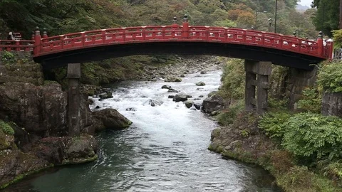 Red old bridge with river from Ryuzu waterfall in Nikko Stock Footage 104532318