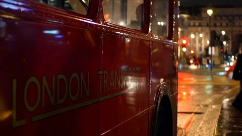 Red old design double decker bus reflects Trafalgar traffic, London, UK 4k Stock Footage 116138354
