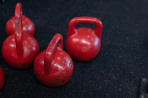 Red old Kettlebell standing black floor with copy space Fitness concept backg Stock Photos
