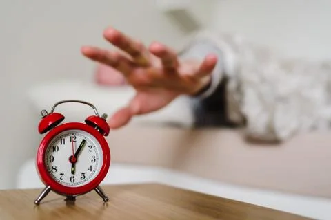 Red old style clock with sleeping man on background Stock Photos
