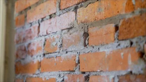 Red Old Weathered Brick Wall. Brick wall with putty. Wall repair. Stock Photos
