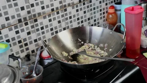 Red onion and garlic fried in a pan Stock Footage 242569799