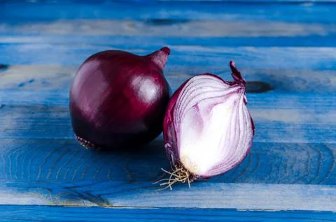 Red onion on a blue background Stock Photos