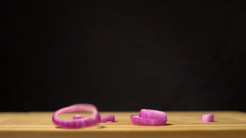 Red Onion falls on the kitchen board. Slow motion Stock Footage 89889278