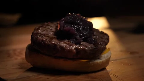 Red onion on hamburger 100fps Stock Footage 229933529