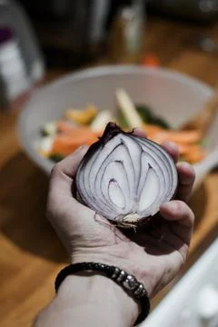 Red onion in hand Stock Photos