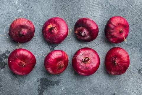 Red onions, on gray background, top view flat lay Stock Photos