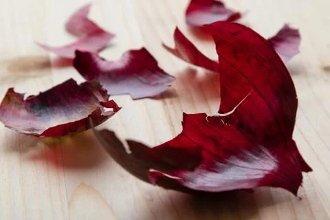 Red onionskin on table Stock Photos