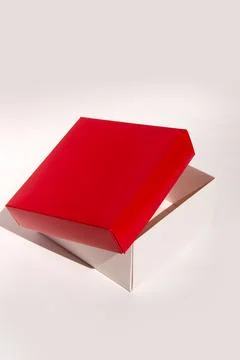 Red open box on white background displaying standard packaging design Stock Photos