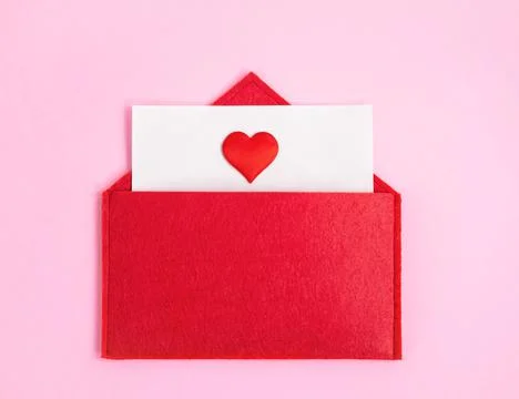 Red open envelope with a sheet of paper with a heart on a pink background wit Stock Photos