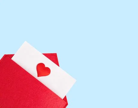 Red open envelope with a sheet of paper with a heart on a blue background wit Stock Photos