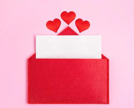 Red open envelope with a sheet of paper with a hearts on a pink background wi Stock Photos