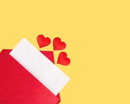 Red open envelope with a sheet of paper with a hearts on a yellow background Stock Photos