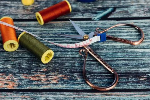 The red, orange and green thread spool. Scissors and seamstress tape measure  写真素材