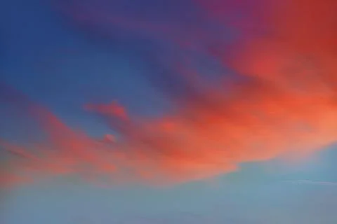 Red orange clouds in dramatic sunset sky 写真素材