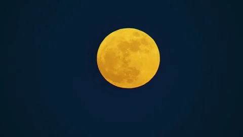 Red orange gradient glowing supermoon with visible craters and celestial Stock Footage 249982612