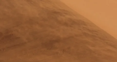 Red orange sand dune wave patterns with wind blowing sand. Stock Footage 102165543
