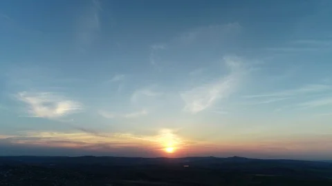 Red orange sunset cloudscape over blue evening sky with mountains silhouette on Stock Footage 127174107