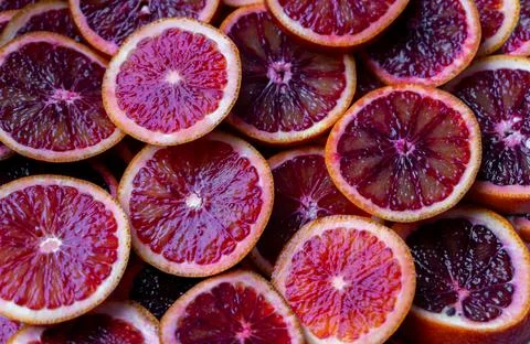 Red oranges fruit background. Sliced juicy orange. Food. Summer concept. Close Stock-Fotos