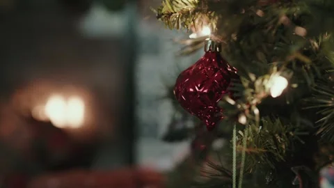 Red ornament on tree next to fireplace Stock Footage 295964793
