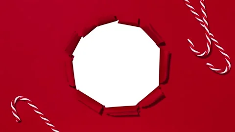 Red packaging paper unwrapping from the center revealing a green screen Stock Footage 224722452