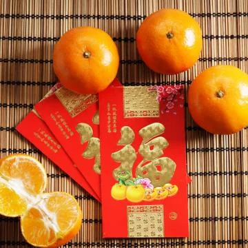 Red packets and mandarin oranges, golden Chinese letter means luck Photos