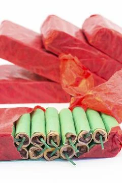 Red packets with stack of green firecrackers isolated on white background Stock Photos