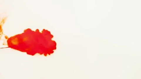 Red paint is added to the white background, which mixes with each other. Stock Footage 276921739