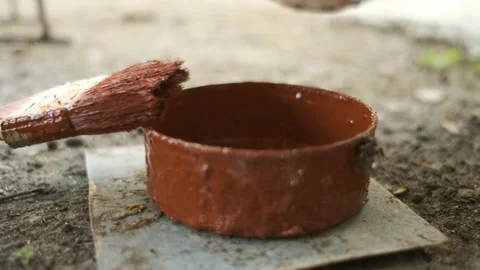 Red paint casting. Dilution to liquid Stock Footage 130983389